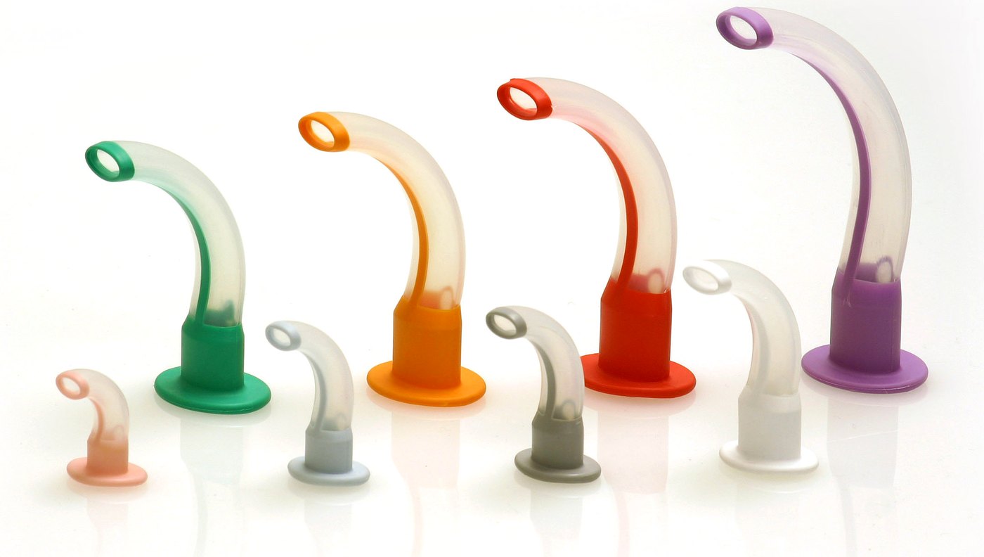 Several sizes of curved oropharyngeal airways with colored flanges.